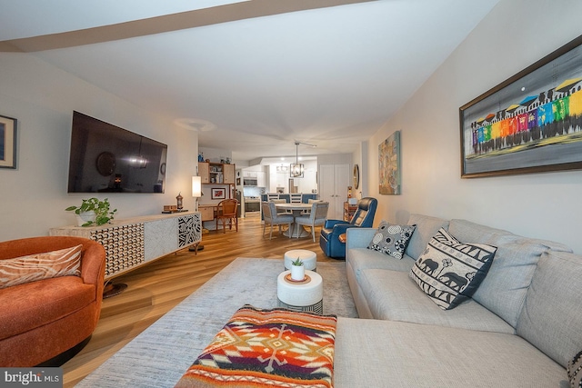 living room featuring a chandelier and hardwood / wood-style flooring