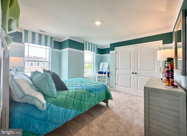 carpeted bedroom featuring a closet and ornamental molding