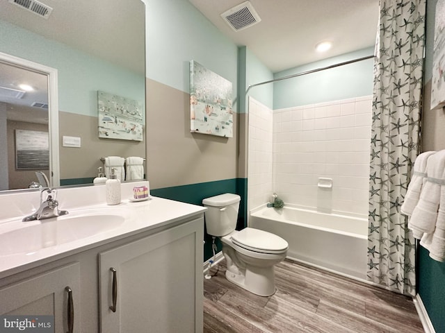 full bathroom featuring shower / bath combo with shower curtain, wood-type flooring, vanity, and toilet