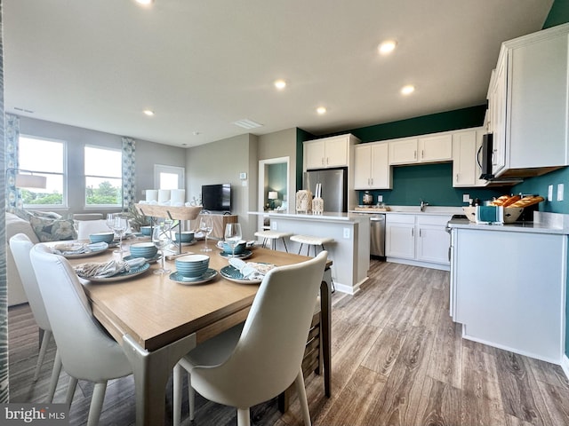 dining room featuring sink and light wood-type flooring