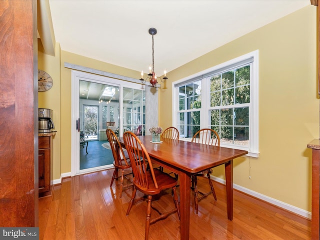 dining space with an inviting chandelier and hardwood / wood-style floors