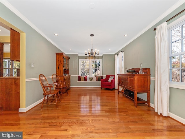 sitting room with a notable chandelier, crown molding, and light hardwood / wood-style flooring