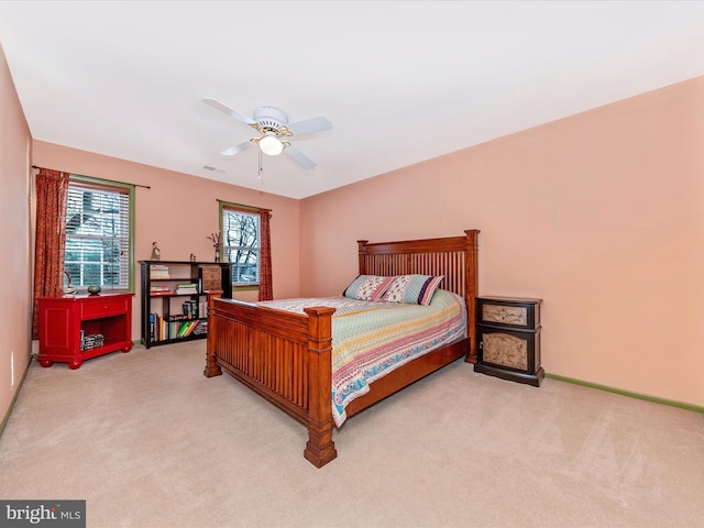 bedroom featuring light colored carpet and ceiling fan