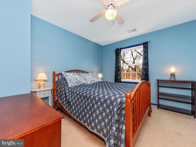 bedroom featuring light carpet and ceiling fan