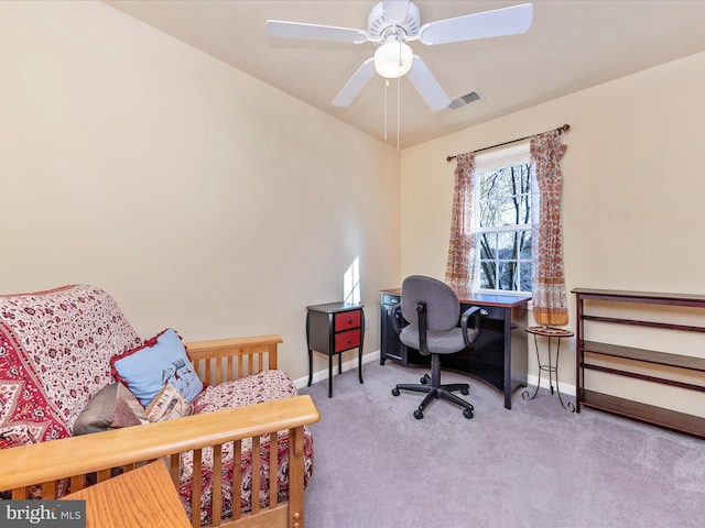 carpeted office featuring ceiling fan