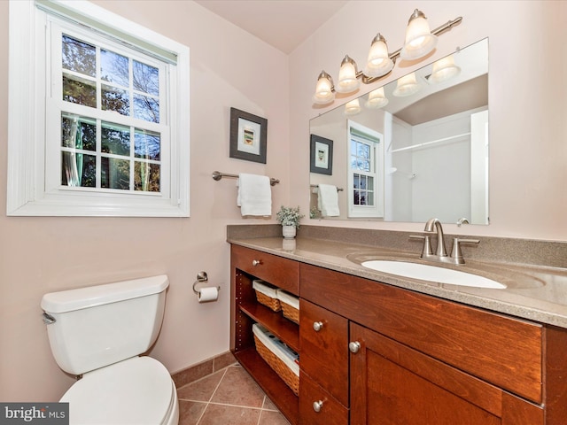 bathroom with tile patterned flooring, vanity, and toilet