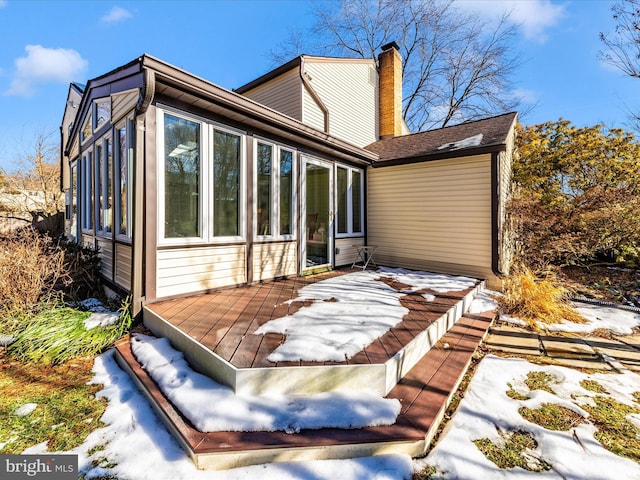 rear view of house with a deck and a sunroom