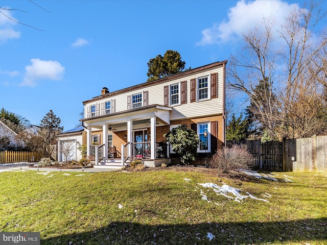 view of front property with covered porch and a front lawn