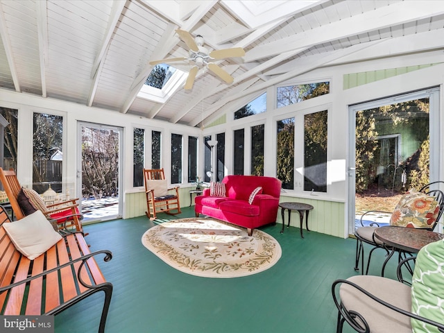 sunroom / solarium featuring a healthy amount of sunlight and vaulted ceiling with skylight