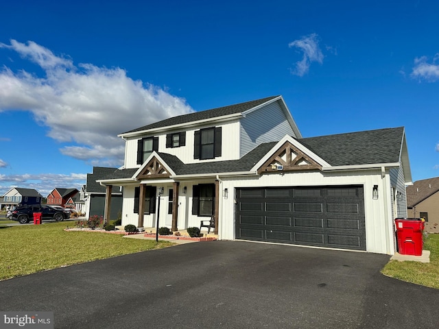 view of front of house with a garage and a front lawn