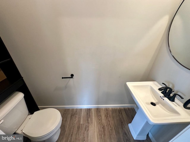 2040 Jelena Rd, Shippensburg, PA 17257 - bathroom with wood finished floors, toilet, baseboards, and a sink