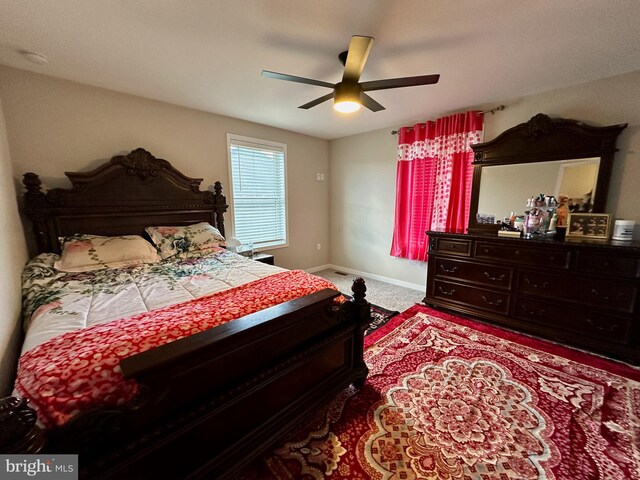 bedroom with ceiling fan and light colored carpet