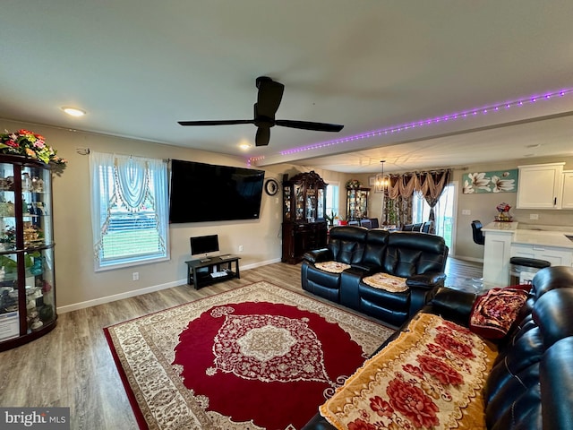 living room with hardwood / wood-style flooring, plenty of natural light, and ceiling fan