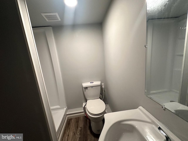 2040 Jelena Rd, Shippensburg, PA 17257 - bathroom with wood finished floors, toilet, a shower, and baseboards