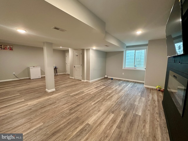 basement featuring light hardwood / wood-style floors