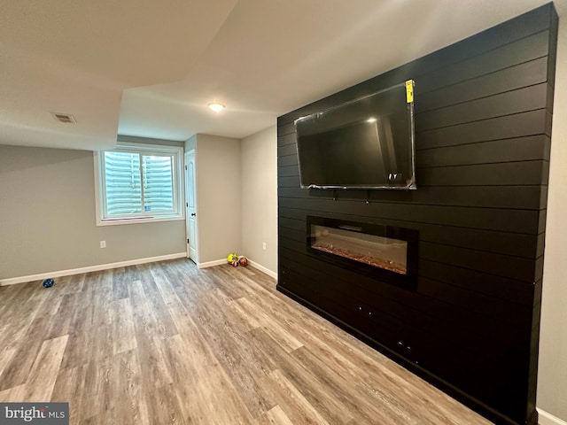 unfurnished living room with a fireplace and hardwood / wood-style flooring