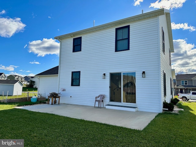 rear view of house featuring a patio area and a yard