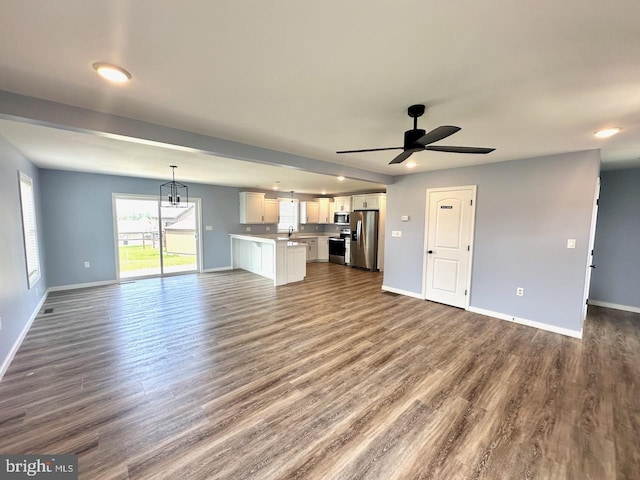 2040 Jelena Rd, Shippensburg, PA 17257 - unfurnished living room with baseboards, ceiling fan, and dark wood finished floors