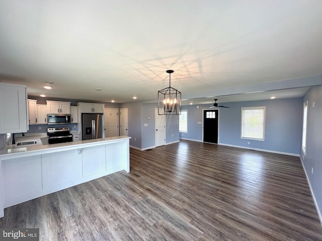 2040 Jelena Rd, Shippensburg, PA 17257 - kitchen featuring stainless steel appliances, baseboards, light countertops, ceiling fan, and open floor plan