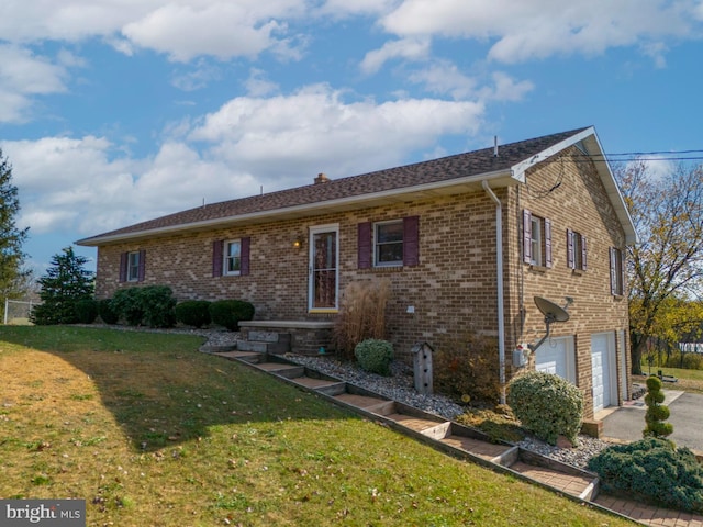 view of front of home featuring a garage and a front lawn