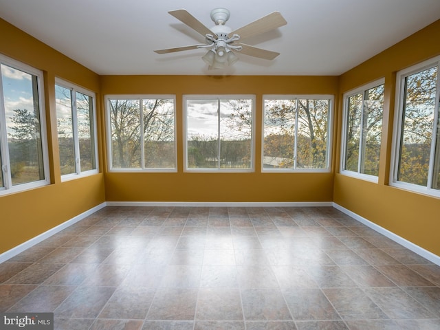 unfurnished sunroom featuring a wealth of natural light and ceiling fan