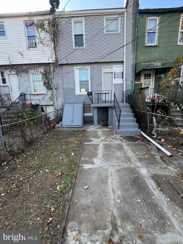 back of house featuring cooling unit