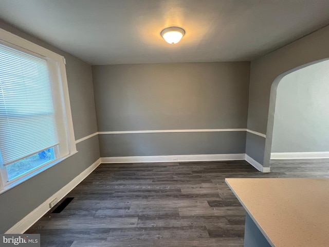 empty room with dark hardwood / wood-style floors