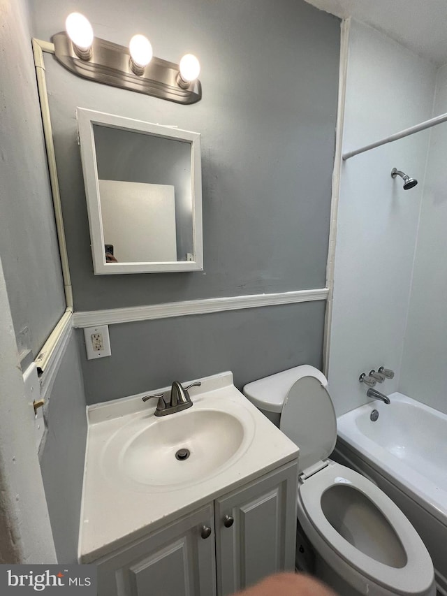 full bathroom with shower / bath combination, vanity, and toilet