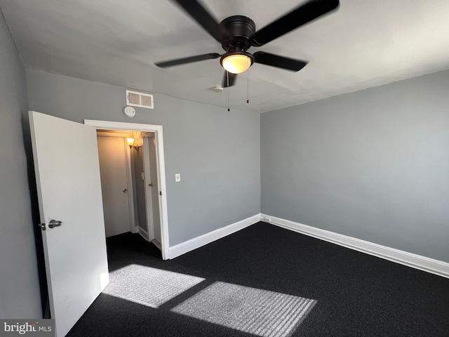 carpeted spare room featuring ceiling fan