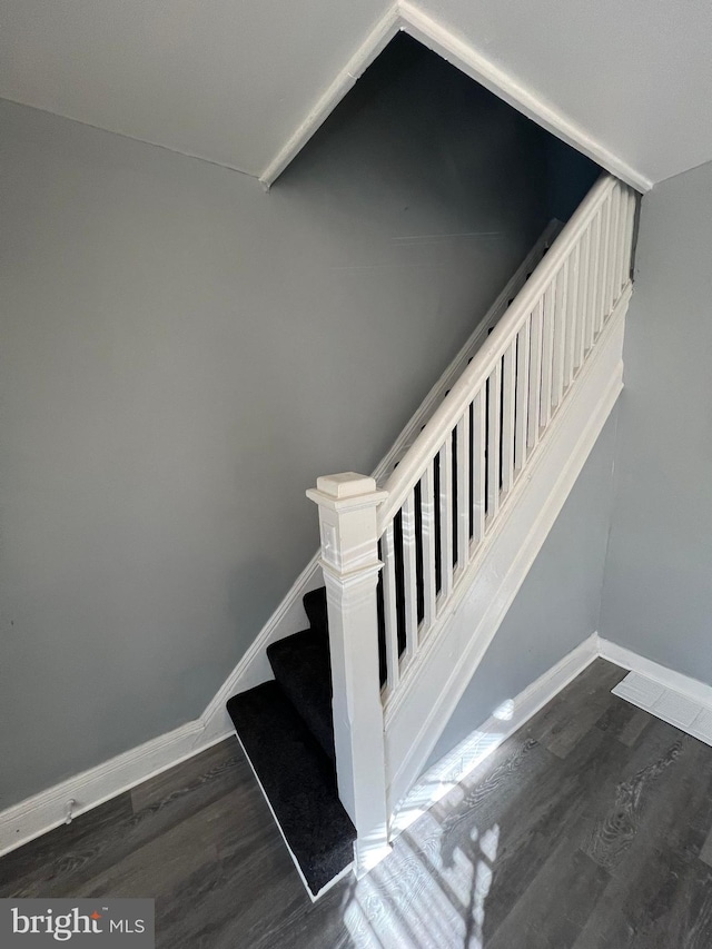 stairway with hardwood / wood-style flooring