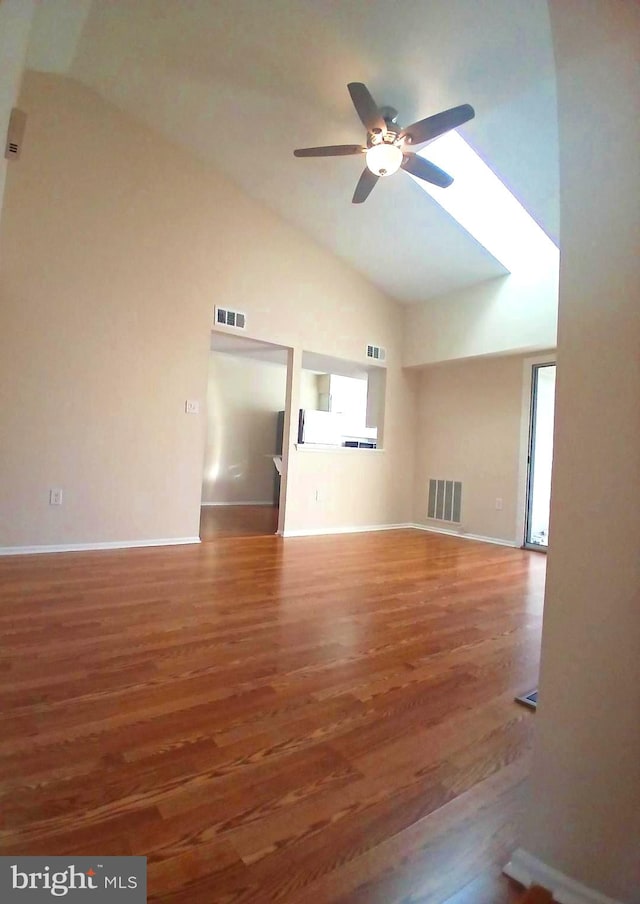 unfurnished living room with ceiling fan, high vaulted ceiling, and hardwood / wood-style flooring