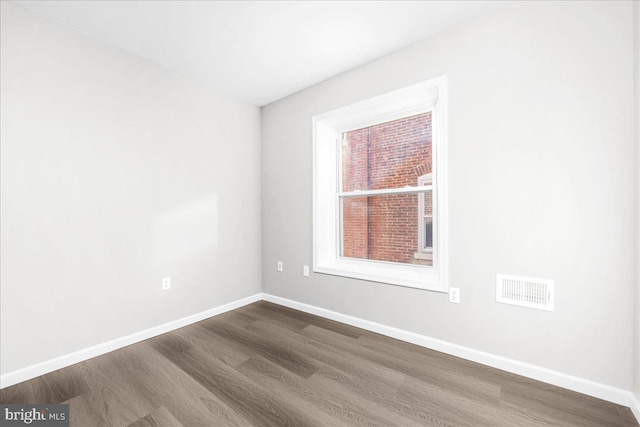 spare room with hardwood / wood-style flooring