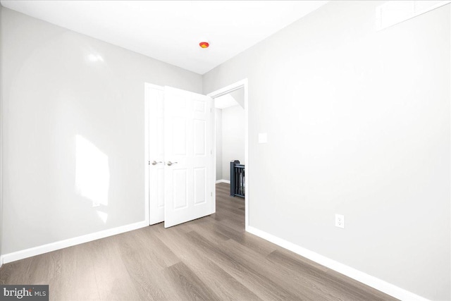 unfurnished room with light hardwood / wood-style floors