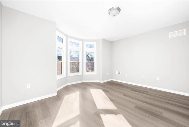 spare room with hardwood / wood-style flooring