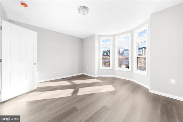 spare room with light hardwood / wood-style flooring