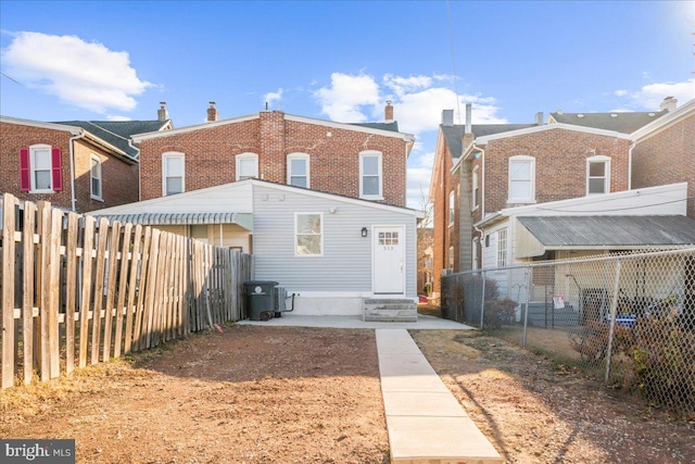 rear view of house with central AC unit