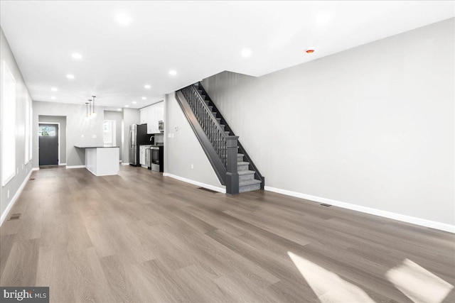 unfurnished living room with light hardwood / wood-style flooring