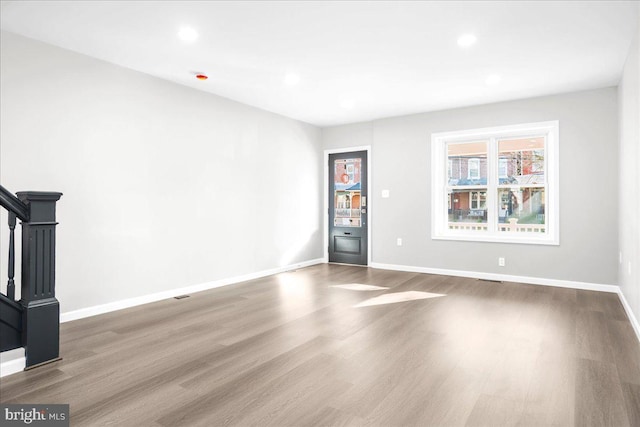 unfurnished living room featuring hardwood / wood-style floors