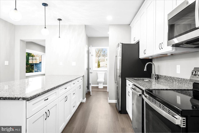 kitchen with a healthy amount of sunlight, white cabinetry, and stainless steel appliances