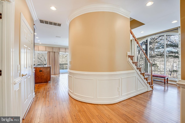 hall with hardwood / wood-style floors and crown molding