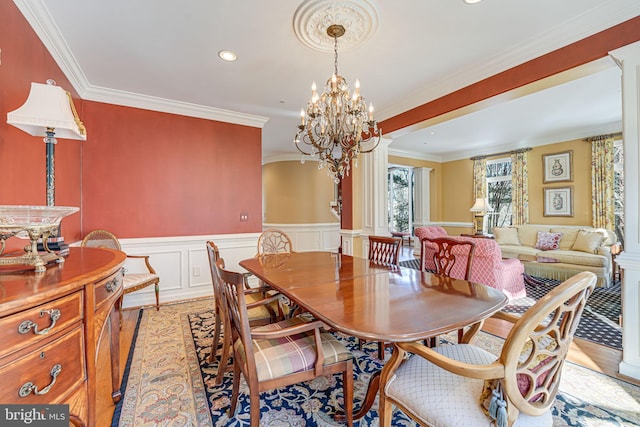 dining room with light wood-type flooring and ornamental molding