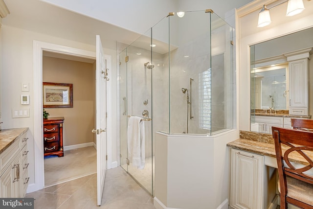 bathroom featuring walk in shower, tile patterned floors, and vanity