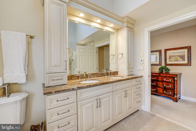 bathroom featuring vanity, toilet, and tile patterned flooring