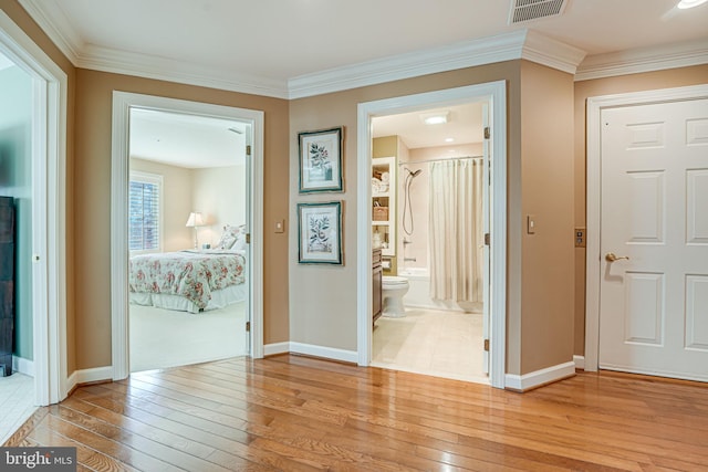 corridor featuring crown molding and light wood-type flooring