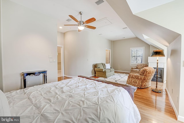 bedroom featuring ceiling fan, lofted ceiling, and hardwood / wood-style flooring