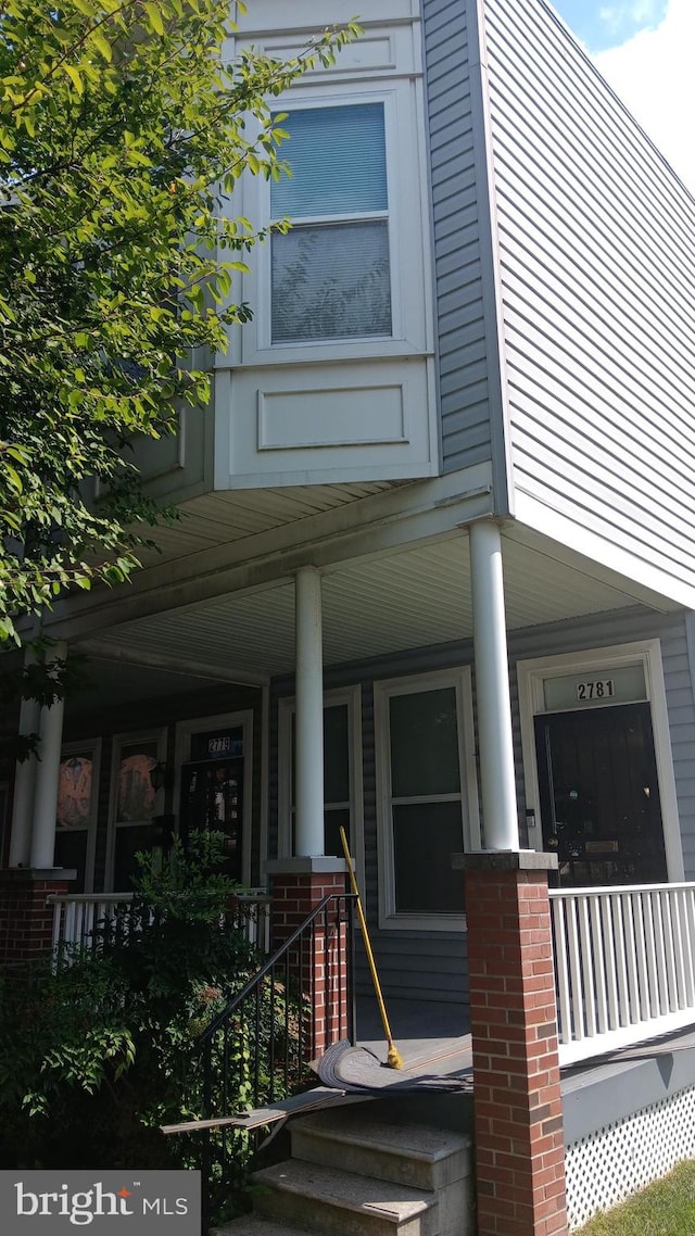 view of exterior entry with covered porch