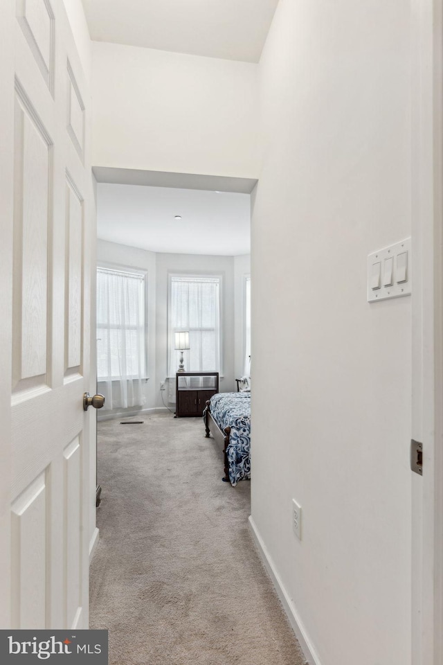 corridor with light colored carpet