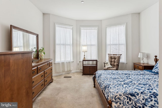 bedroom with light colored carpet