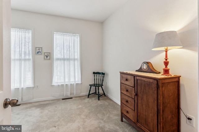 living area with light carpet