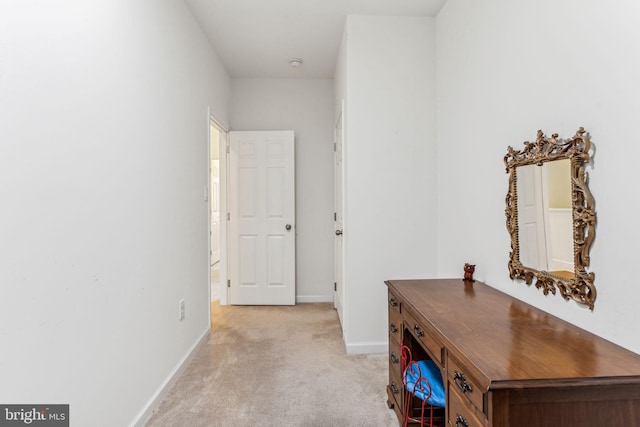 hall featuring light colored carpet